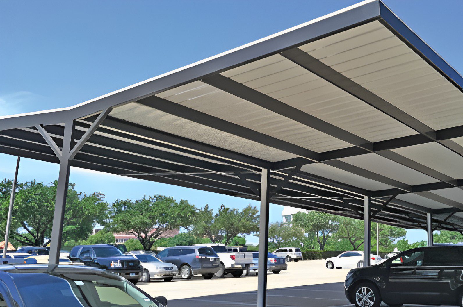 Metal carport with multiple cars parked.