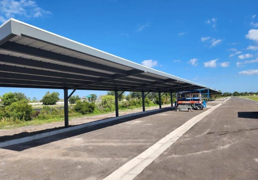 Metal carport structure with blue sky.